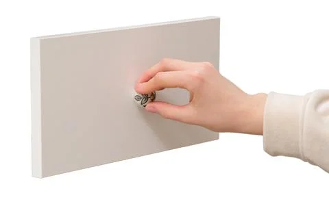 Woman hand pulling or pushing white wooden cabinet drawer with decorative cer Stock Photos