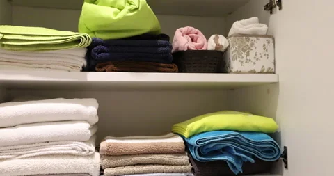 Woman hand sorting things on shelves inside bathroom closet during home cleaning Stock Footage 345424833