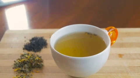 Woman hand with spoon adding sugar to tea cup and mixing Stock Footage