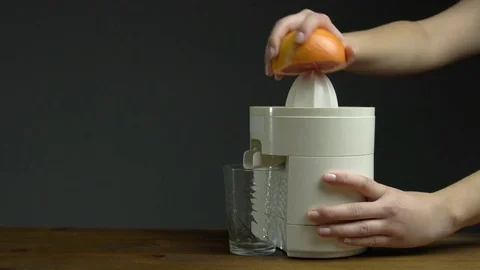 Woman Hand with Squeezer Squeezing Grapefruit Juice Isolated Grey Background Stock Footage 76521558