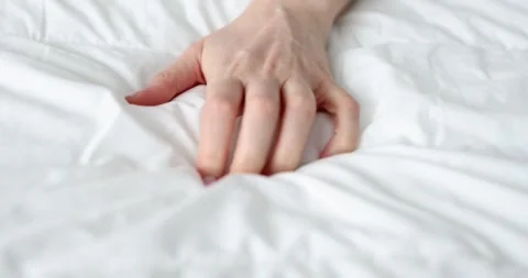 Woman hand squeezing white bed during passionate orgasm closeup 4k movie slow Stock Footage 278071697