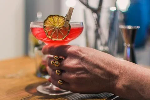Woman hand takes served cocktail Stock Photos