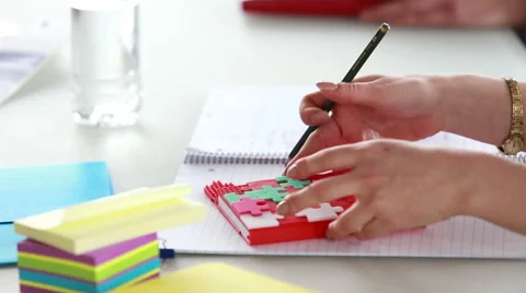 Woman hand taking notes in puzzle notebook during a meeting Stock Footage 59542371