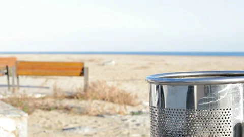 Woman hand throwing trash on the floor on the beach Stock Footage 127612853