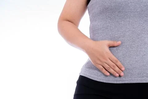 Woman hand touching stomach, waist, or liver position isolated white backgrou Stock Photos