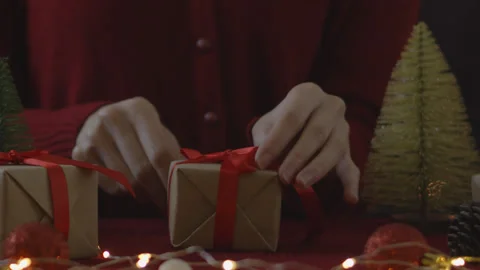 Woman hand untie ribbon at gift box on table for christmas and new year concept Stock Footage