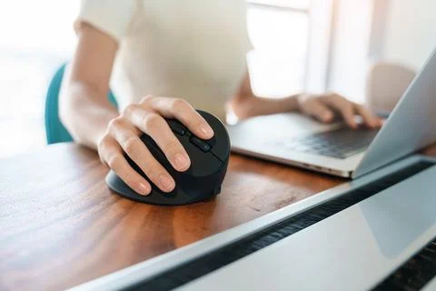 Woman hand using computer ergonomic mouse, prevention wrist pain because work Stock Photos