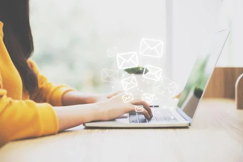 Woman hand using computer laptop pc with email icon. Concept of email and con Stock Photos