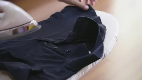 Woman hand using iron to fix the wrinkle from the cloth Stock Footage