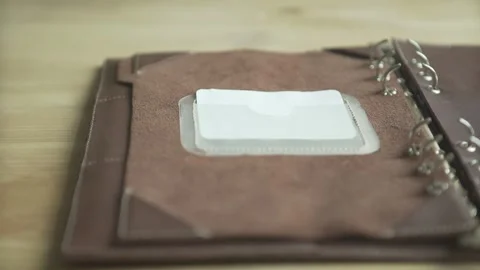 Woman hand using light brown leather case elegant note pad book daily planner ha Stock Footage 137538932