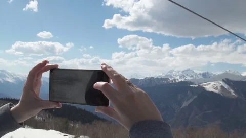 Woman hand using mobile phone photo. Mountain nature Stock Footage