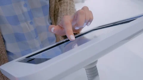 Woman hand using touchscreen display of floor standing white tablet kiosk Stock Footage 122739931