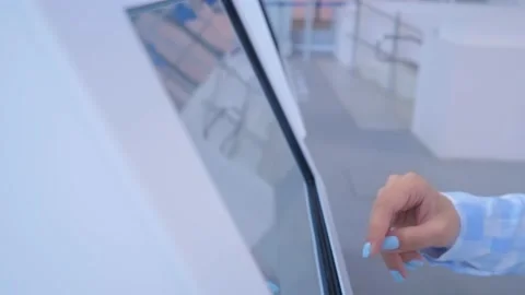 Woman hand using touchscreen display of interactive kiosk at exhibition Stock Footage 152341611