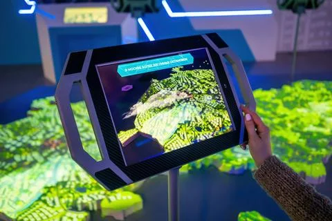 Woman hand using touchscreen display of tablet kiosk with city map - close up Stock Photos