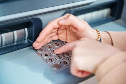 Woman hand while using ATM at street Stock Photos