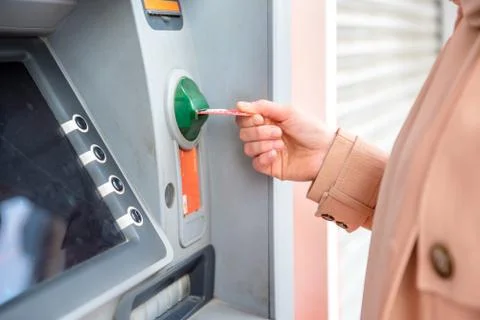 Woman hand while using ATM at street Foto stock