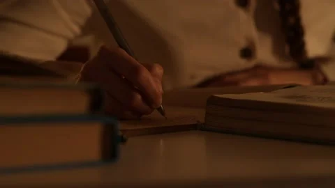 Woman hand write text in notebook out from book in library. Evening. Education Vidéo 156492976