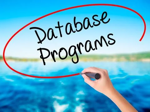 Woman Hand Writing Database Programs with a marker over transparent board. Foto stock