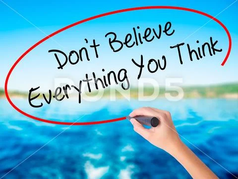 Woman Hand Writing Don't Believe Everything You Think with a mar Stock Photos