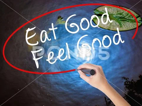 Woman Hand Writing Eat Good Feel Good with marker over transpare Stock Photos