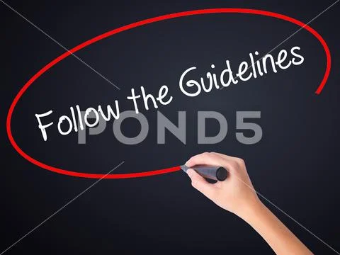 Woman Hand Writing Follow the Guidelines with a marker over tra Stock Photos