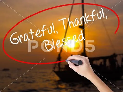 Woman Hand Writing Grateful Thankful Blessed with a marker over Stock Photos