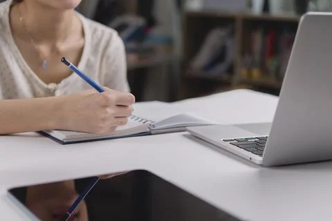 Woman hand writing notes, study online e-learning. Student use laptop compu.. Stock Photos