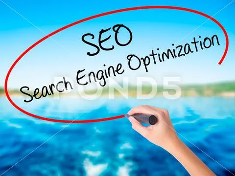 Woman Hand Writing SEO Search Engine Optimization with a marker Stock Photos