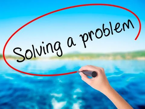 Woman Hand Writing Solving a problem with a marker over transparent board Foto stock