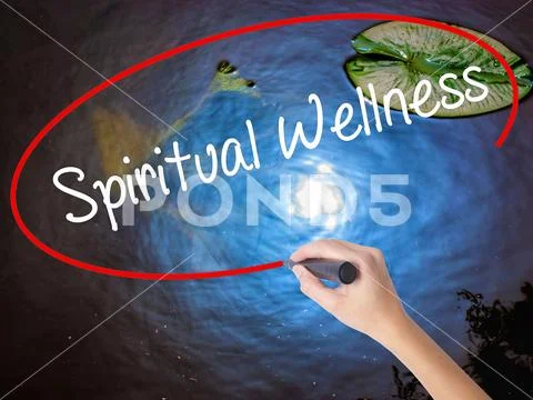 Woman Hand Writing Spiritual Wellness with marker over transparent board Stock Photos