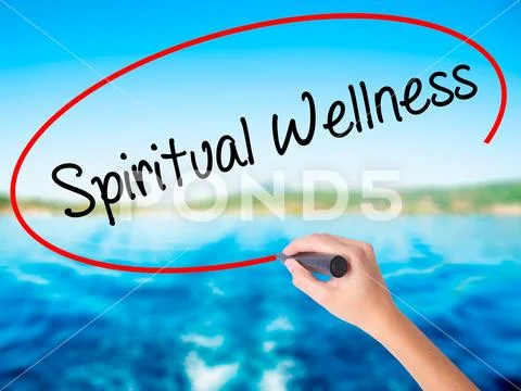 Woman Hand Writing Spiritual Wellness with a marker over transpa Stock Photos