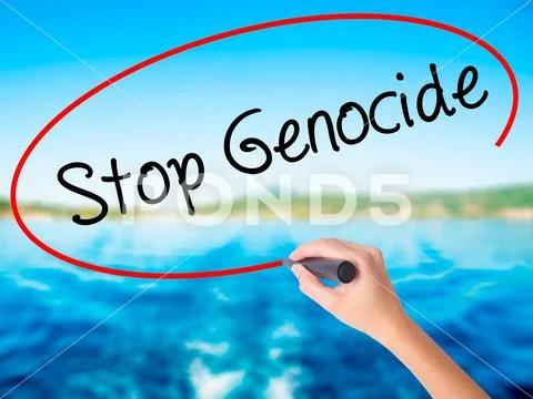 Woman Hand Writing Stop Genocide with a marker over transparent Stock Photos