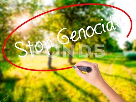 Woman Hand Writing Stop Genocide with a marker over transparent Stock Photos
