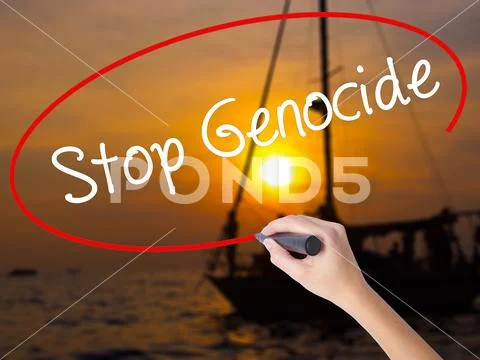 Woman Hand Writing Stop Genocide with a marker over transparent Stock Photos