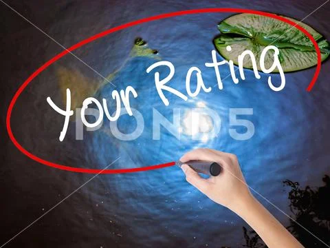 Woman Hand Writing Your Rating with marker over transparent boar Stock Photos