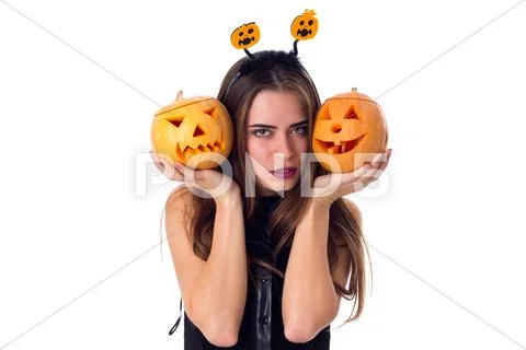 Woman with handband holding two pumpkins Stock Photos