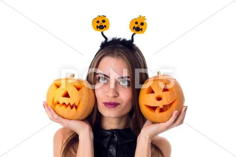 Woman with handband holding two pumpkins Stock Photos