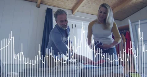 Woman handing clothes while man packing suitcase for travel, audio waveform Stock Footage 330767841