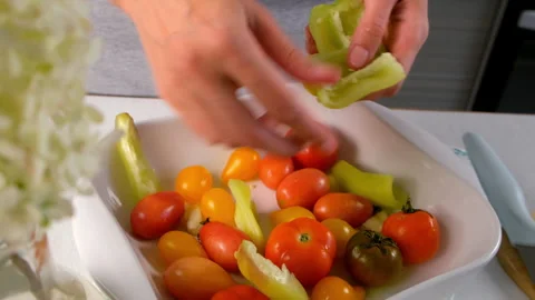 Woman hands adding vegetables to baking sheet with oil to bake vegetables. Video stock 312456432