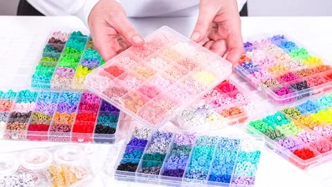 Woman Hands Amidst a Rainbow Array of Beads for Jewelry Crafting 写真素材