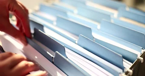 Woman hands are sorting through documents in folder in archive closeup Video stock 235920825