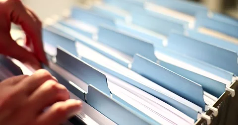 Woman hands are sorting through documents in folder in archive closeup Video stock 263562372
