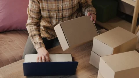 Woman hands checking shipping order on laptop and holding delivery box, onl.. Stock Footage 335000011