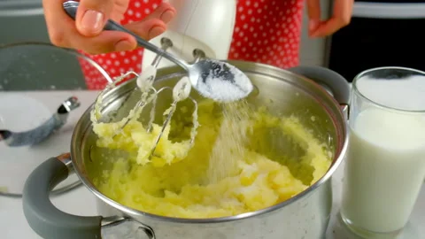 Woman hands cooking preparing mashed potatoes with milk and salt on kitchen. Stock Footage 312402902