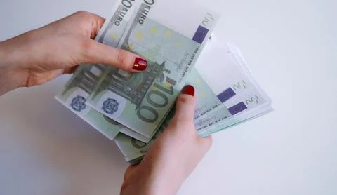 Woman hands counting stack of one hundred euro banknotes. Stock Photos