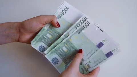 Woman hands counting stack of one hundred euro banknotes. Stock Photos