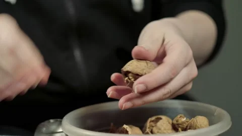 Woman Hands Cracking Walnuts With A Nutcracker Stock Footage 151350617