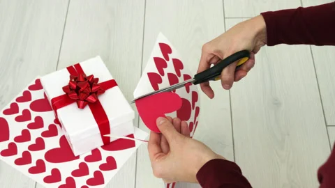 Woman hands cutting out red heart shape from paper cardboard using scissors Stock Footage 180411953