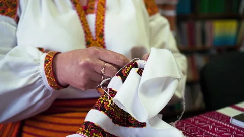 Woman hands doing cross-stitch. A close up of embroidery. Stockbeeldmateriaal 146143853