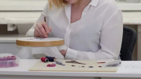 Woman hands embroiders with luneville hook on silk Stock Footage